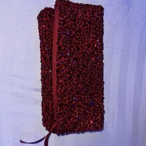 I’m selling a very cute bag it clutches it has red stones al over the bag.